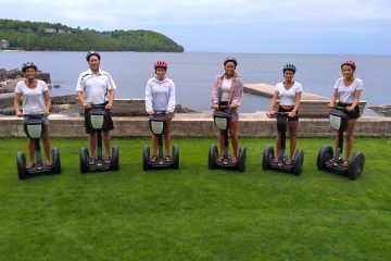 a group of people that are standing in the grass